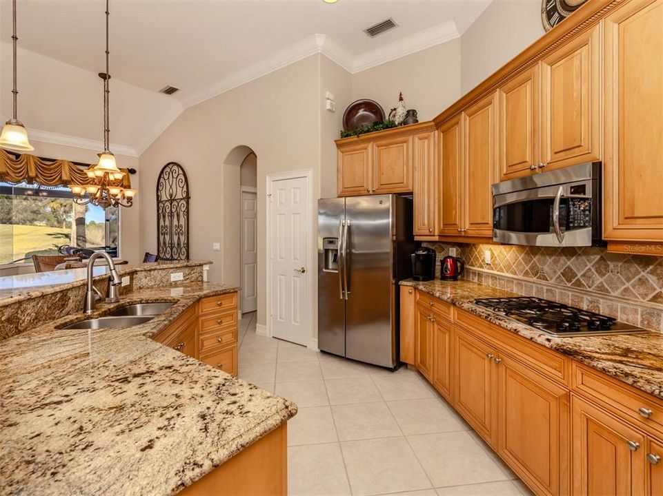 An abundance of cabinetry and counter space plus a wall pantry provides plenty of storage for kitchen essentials.