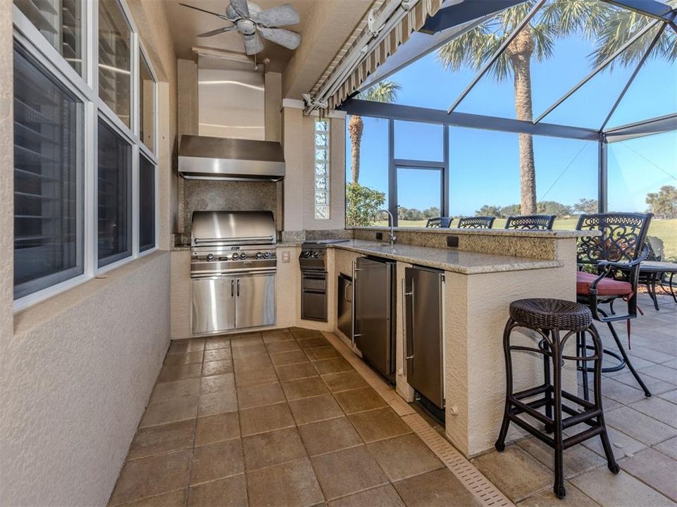 A great outdoor kitchen with bar seating offers the perfect space for entertaining with family and friends.