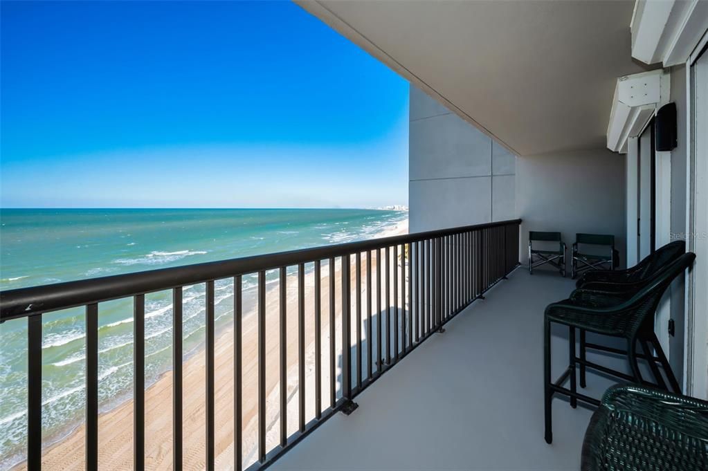 The Balcony off the Sunroom/Dining area and the adjacent Primary Bedroom