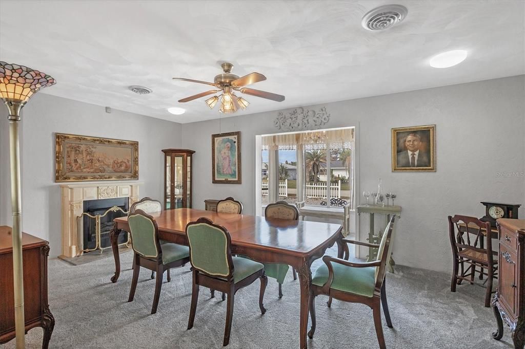 Dining room with beautiful bay window facing the roadside.  The dining room furniture and paintings ARE NOT INCLUDED but could be sold on a separate contract