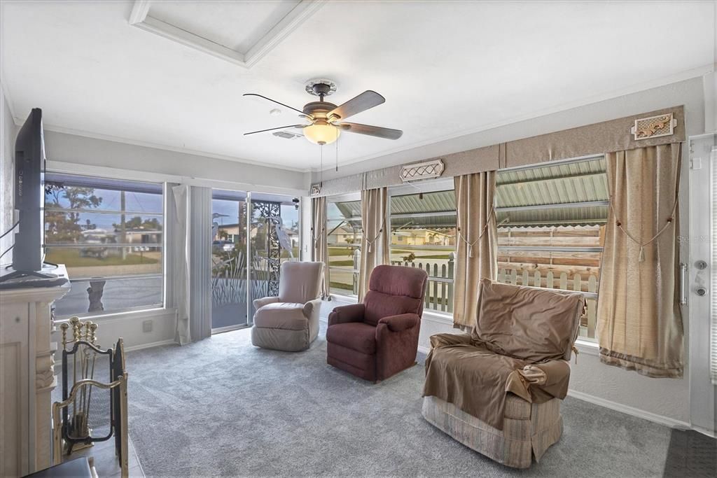 Florida room with plenty of natural light and decorative fireplace