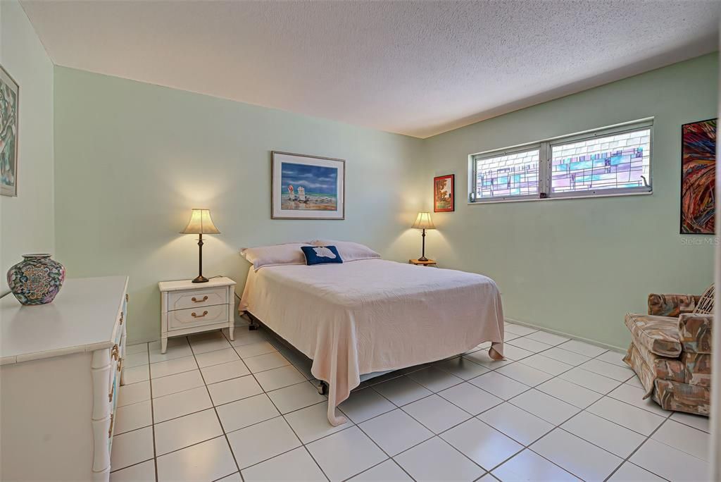 The bedroom is quite large and also tiled and maintenance free.