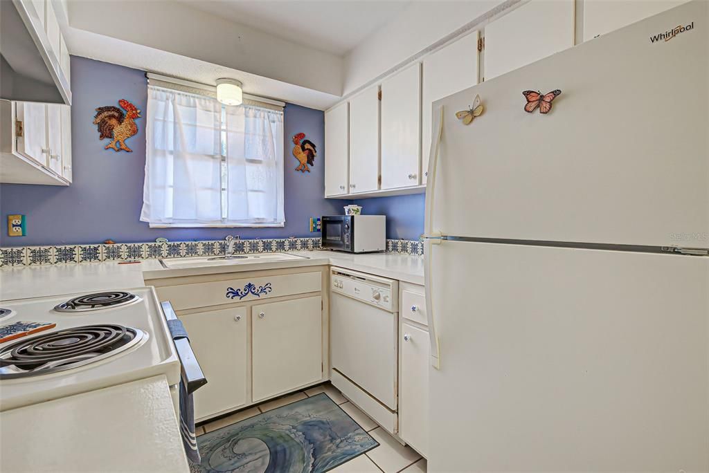 The galley kitchen has plenty of counter space and storage.