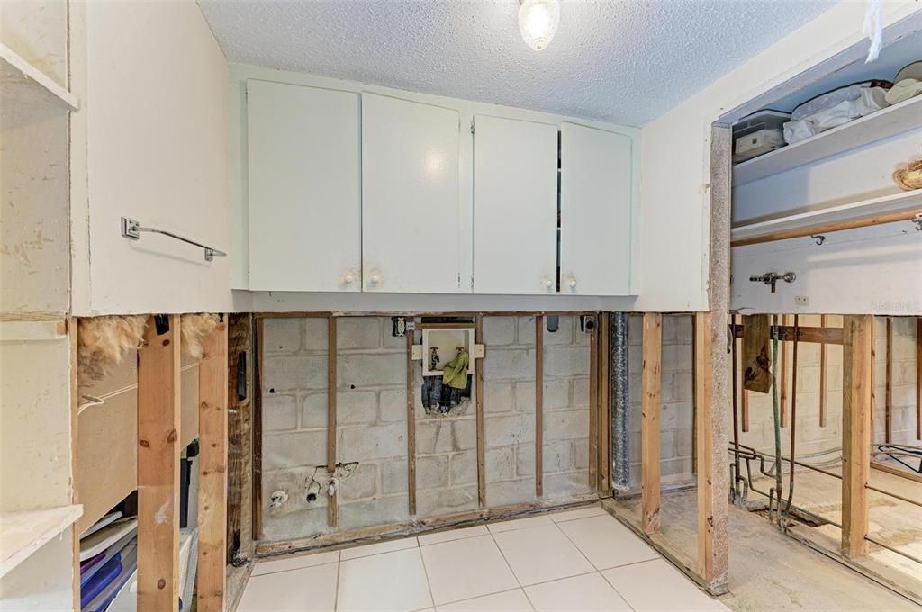 Laundry Room had  sink, washer dryer, cupboards above.