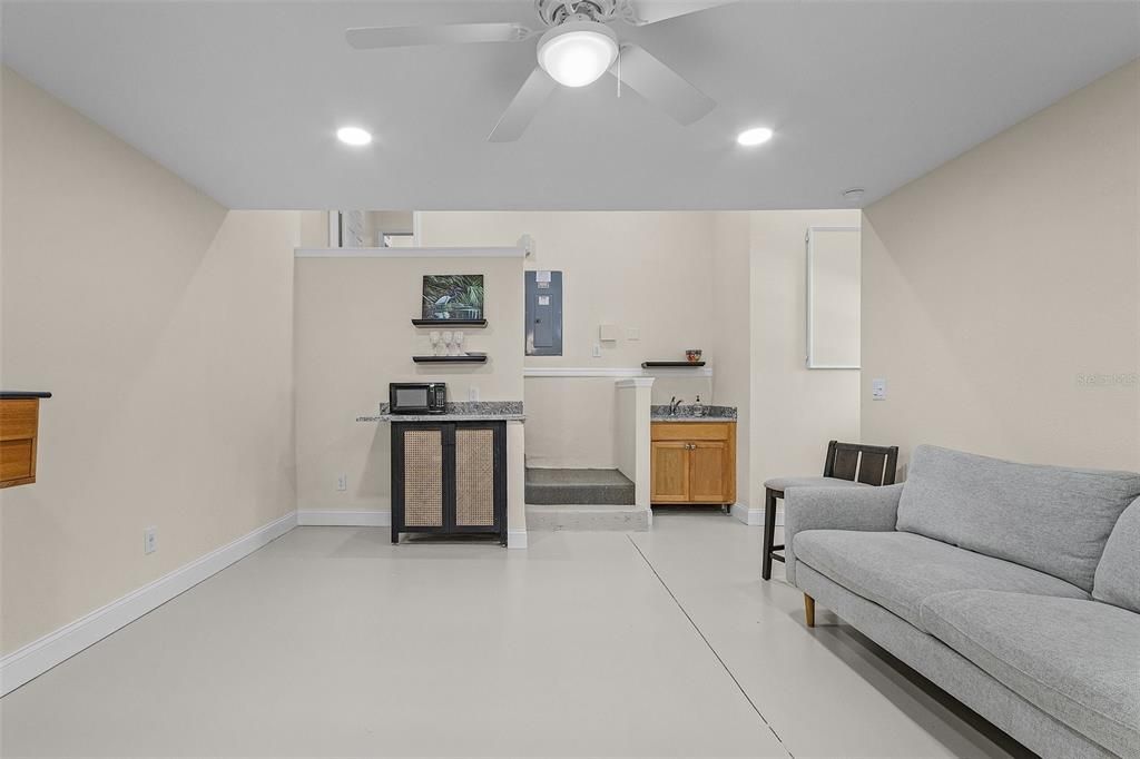 Living room featuring electric panel and ceiling fan