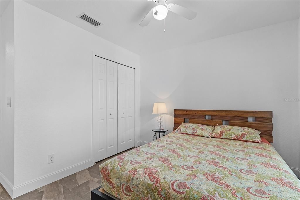 Bedroom with ceiling fan and a closet