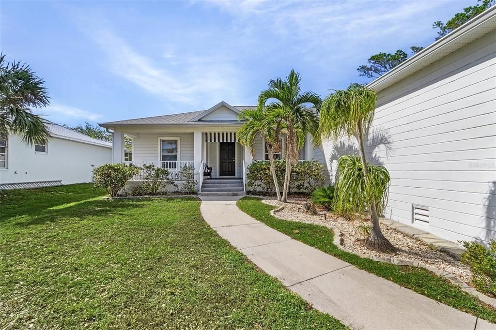 View of front of home featuring covered porch and a front yard