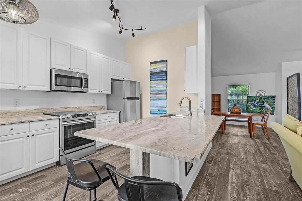 Kitchen featuring sink, white cabinetry, and stainless steel appliances