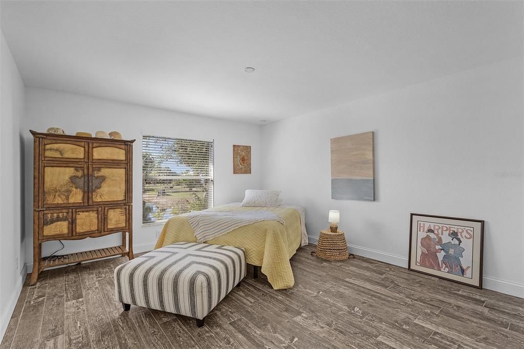 Bedroom with dark hardwood / wood-style floors