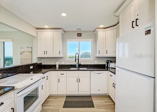 Kitchen with Granite countertops and white Cabinets