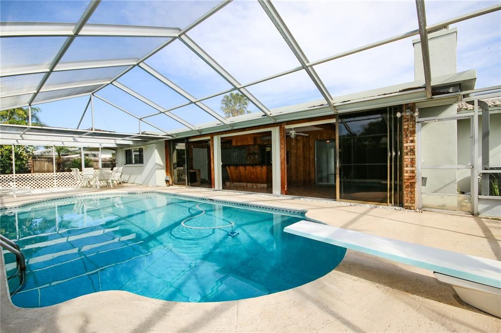 View to Home showing pool and Sunroom