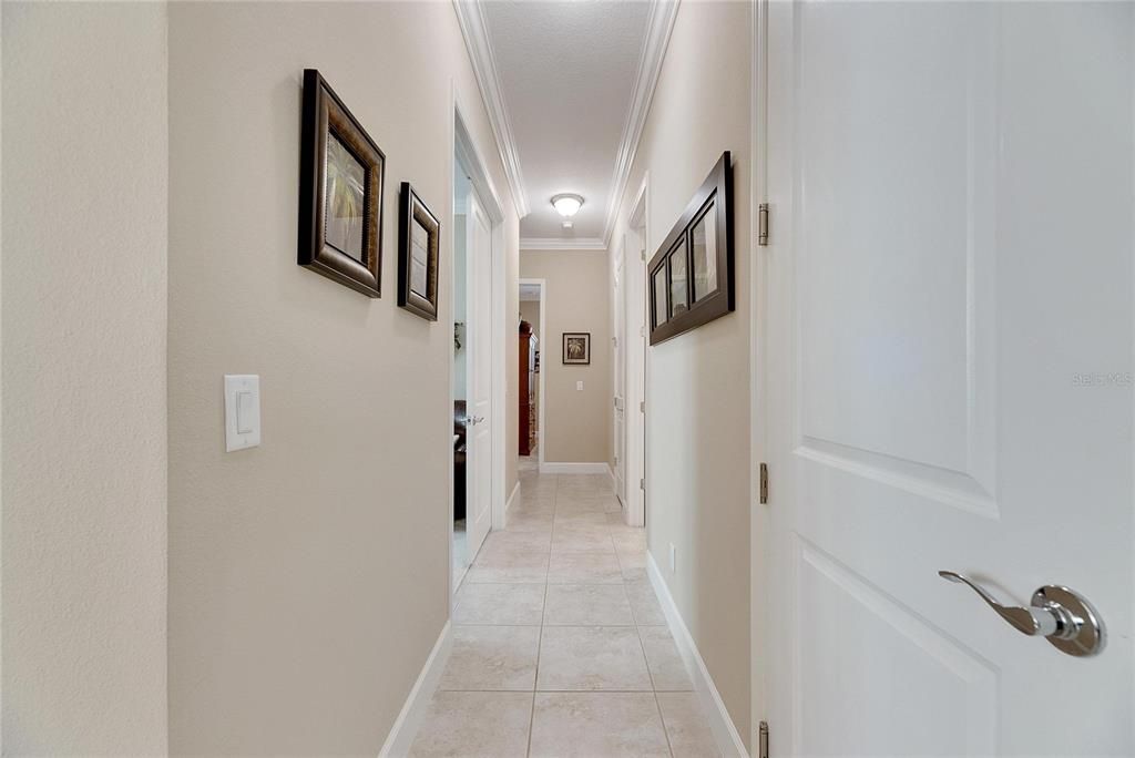 Hallway Leading to the Den, Third Bedroom, Third Full Bath and Single Car Garage