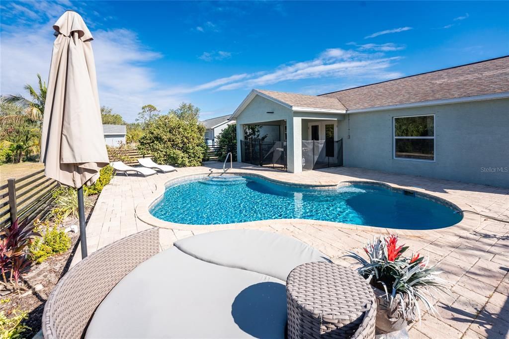 Rear patio with lush landscape