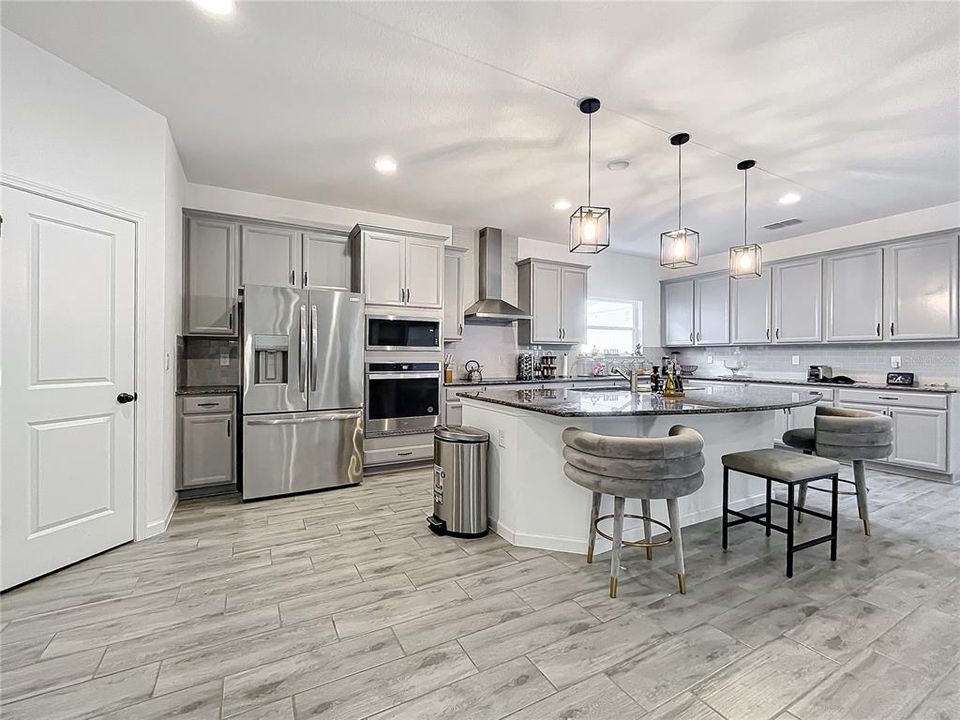 Spacious kitchen with oversized island and stainless steel appliances