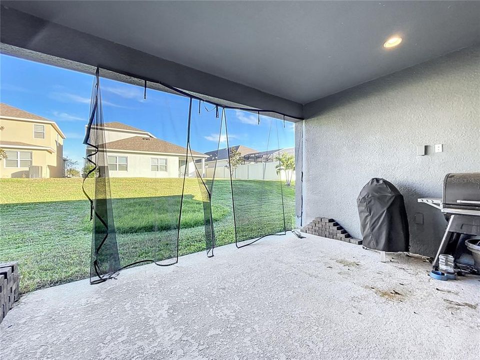 Covered rear porch with a large yard