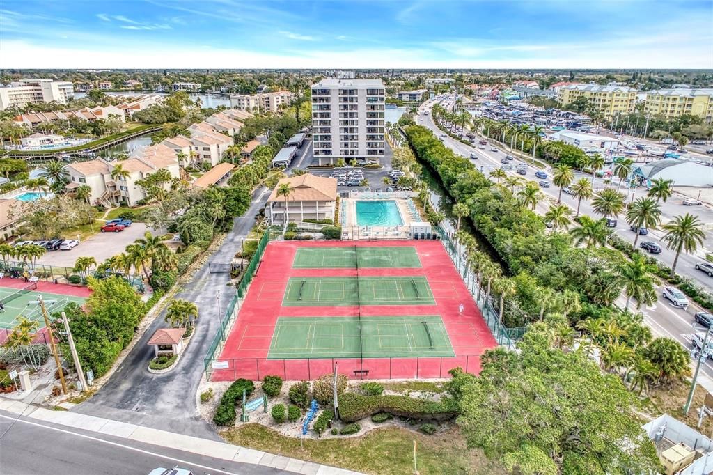 AERIAL VIEW OF GATEHOUSE, PICKELBALL & TENNIS, POOL & CONDO BUILDING