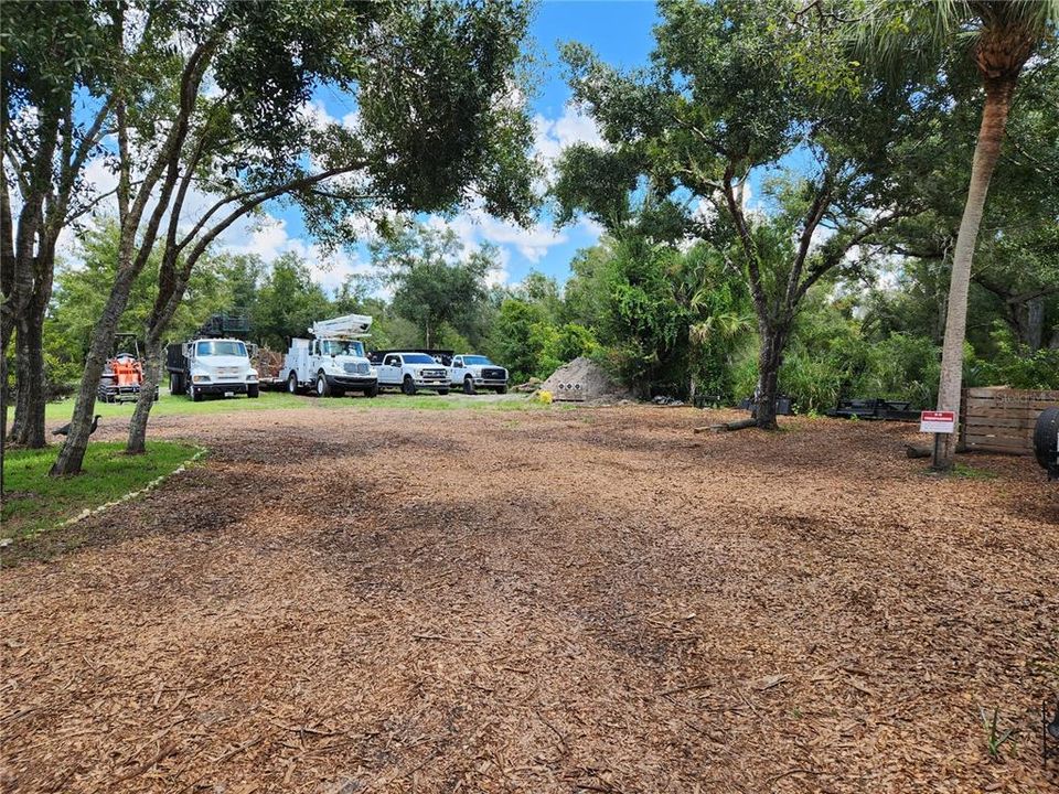 Rear Yard & Owners Work Vehicles Parked on Adjacent Lot