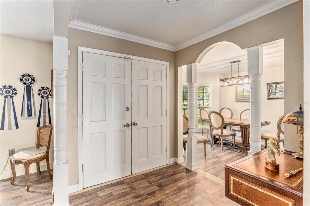 Front door with dining room one side and office/library next to it.