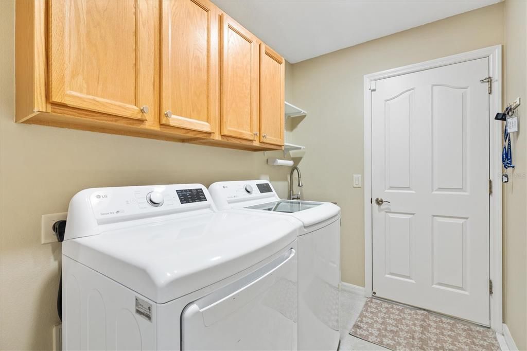 Newer washer and dryer. Cabinets for storage.