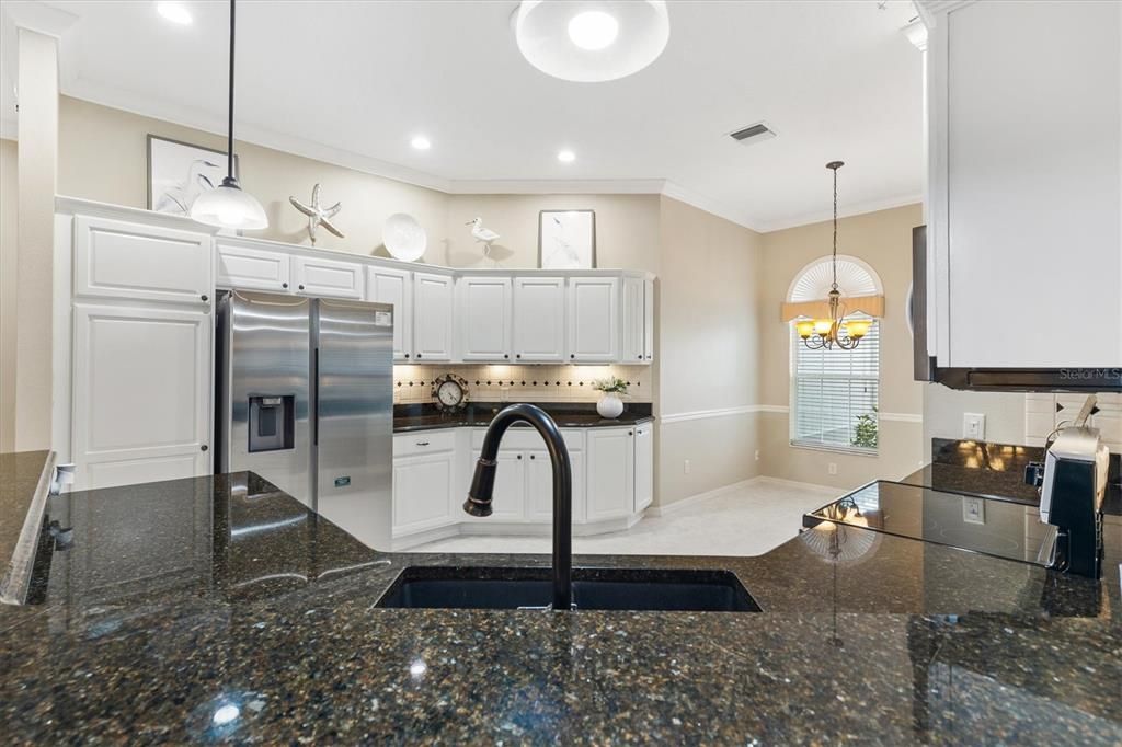 Large kitchen area with kitchen nook.