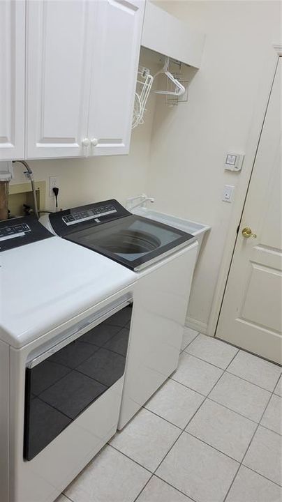 Laundry room with sink and storage