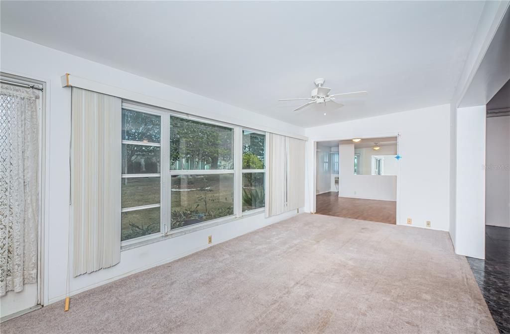 Spacious living room that connects with the living/dining room, the extra room and the back yard