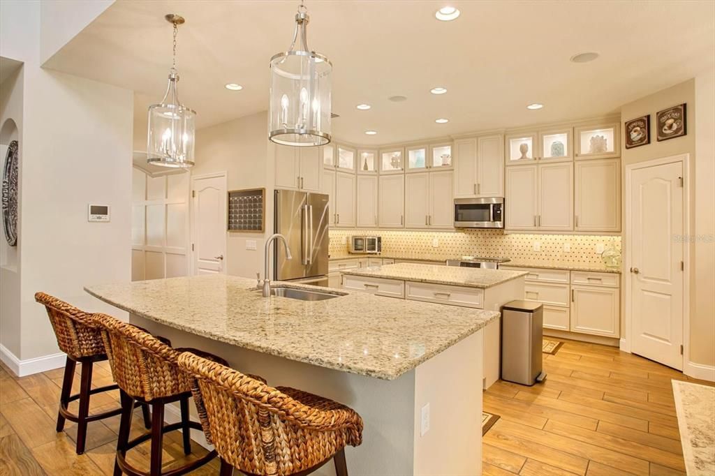 Kitchen - Custom cabinets with soft-close feature, lighting under cabinets and above