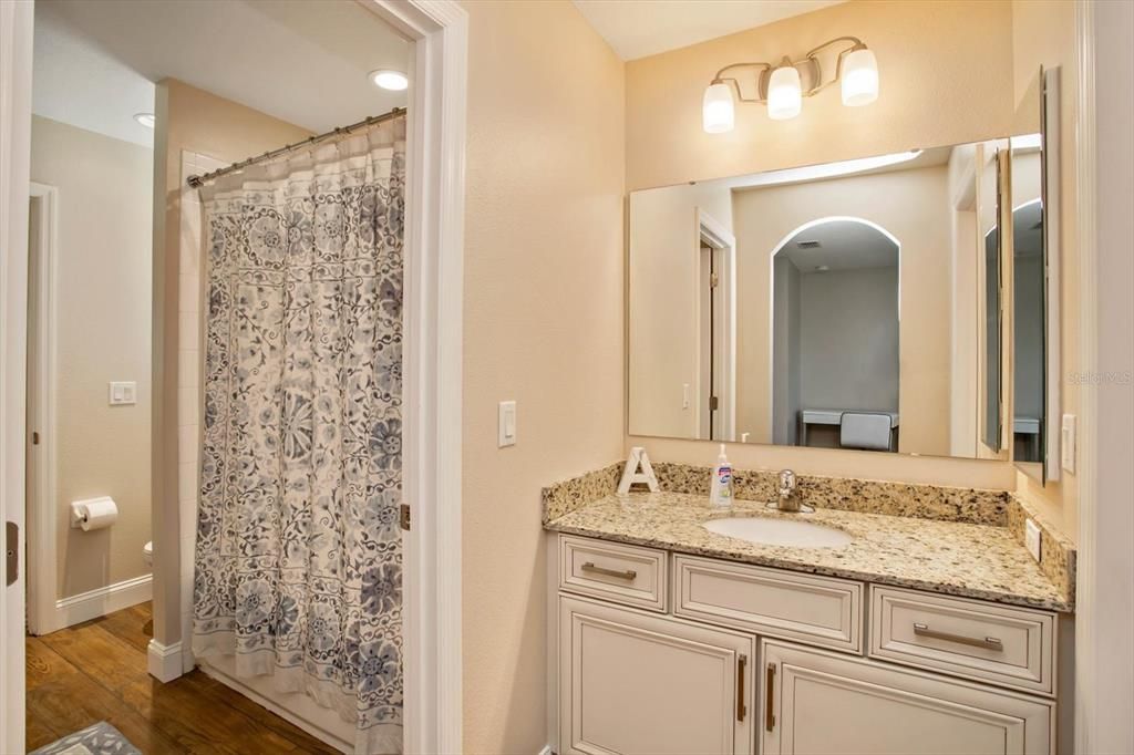 Jack & Jill Bathroom. Sink and cabinets on both sides, tub/shower and toilet in between.