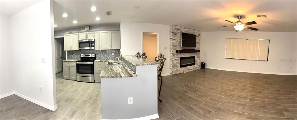 panoramic view of kitchen and living room