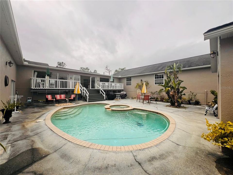 VIEW FROM POOL BATHROOM OF COURTYARD AND POOL