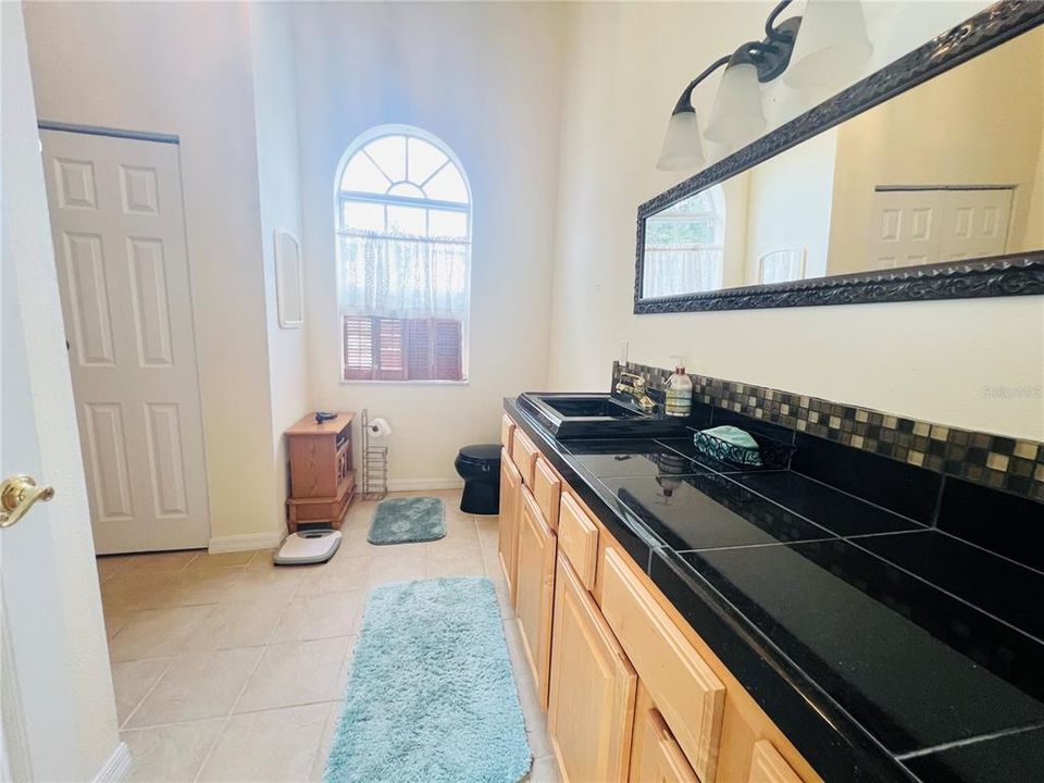 BATHROOM IN LARGE FAMILY ROOM WITH FIRE PLACE ALSO DOOR LEADS TO POOL AREA