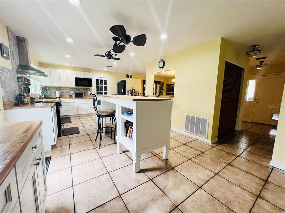 VIEW OF KITCHEN FROM BREAKFAST AREA HALL WAY TO RIGHT THAT LEADS TO 3 BEDS AND 2 BATHS FRONT DOOR LEADS TO OUTDOOR LIVING AREA