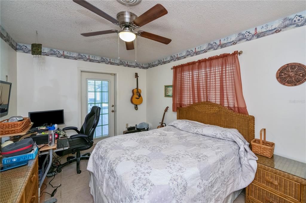 1 of 3 auxiliary bedrooms, doubling currently as a work from home office. Opens to the lanai.