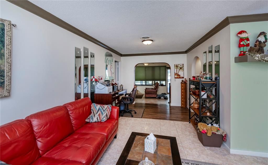 living room flows to the office area and opens to the family room, lanai & pool