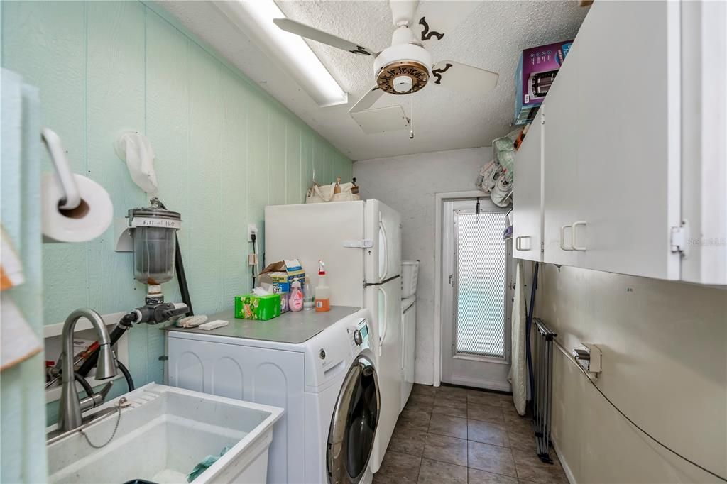 well-equipped laundry/utility room, opening to the side yard