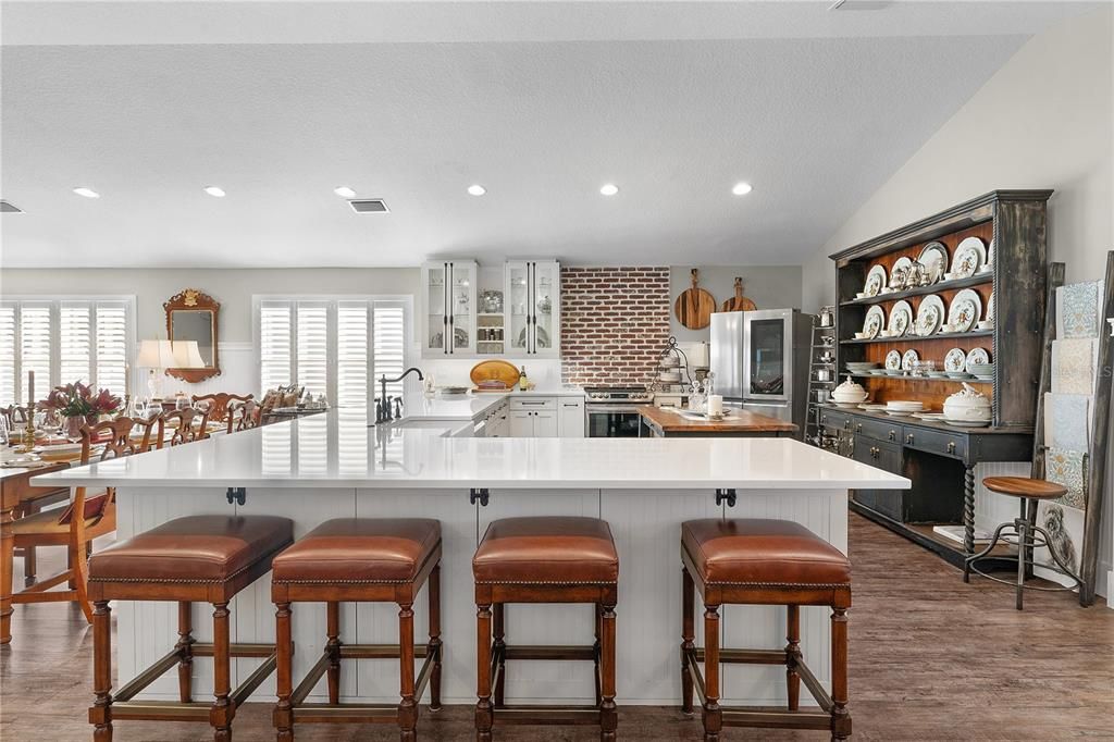 WHAT A GREAT BREAKFAST BAR FOR CASUAL DINING AND PLENTY OF EXTRA STORAGE SPACE THE ENTIRE LENGTH OF THE L SHAPED COUNTER.