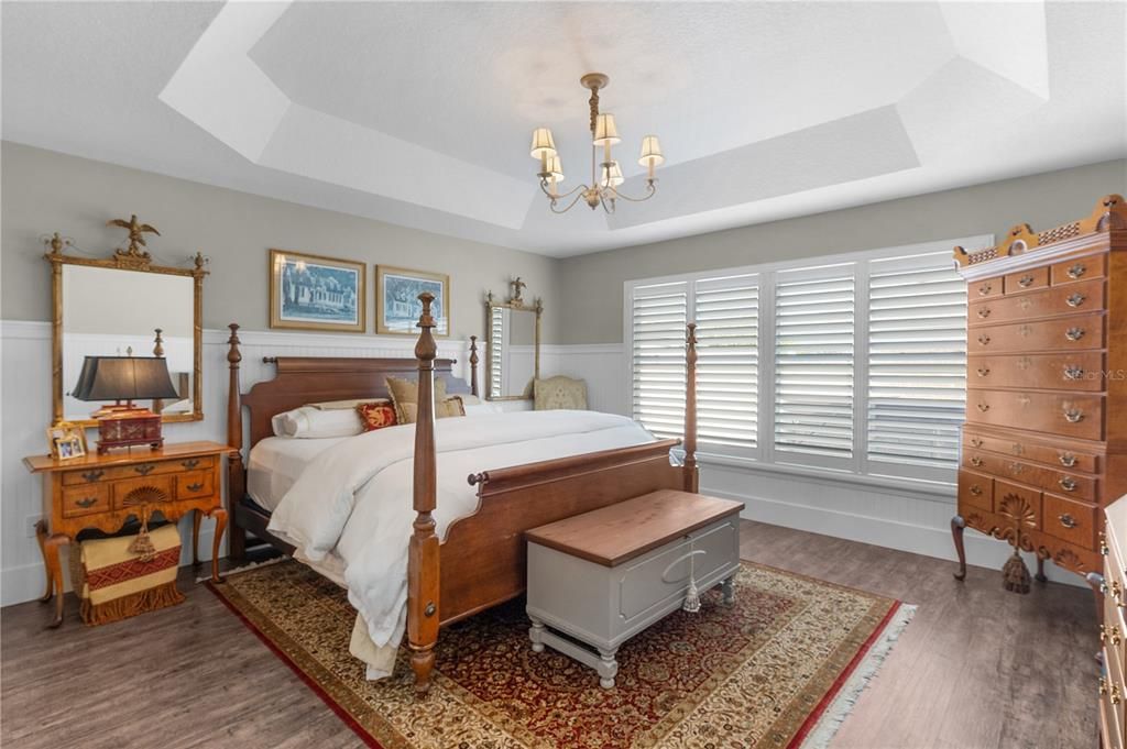 PRIMARY BEDROOM WITH LOVELY CHANDELIER, TRAY CEILING AND EN-SUITE BATH.