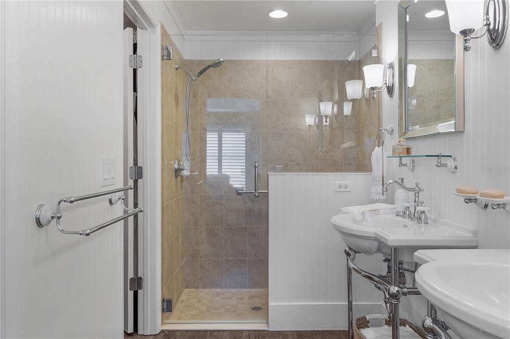 FRAMELESS GLASS ENCLOSED LOVELY TILED SHOWER.