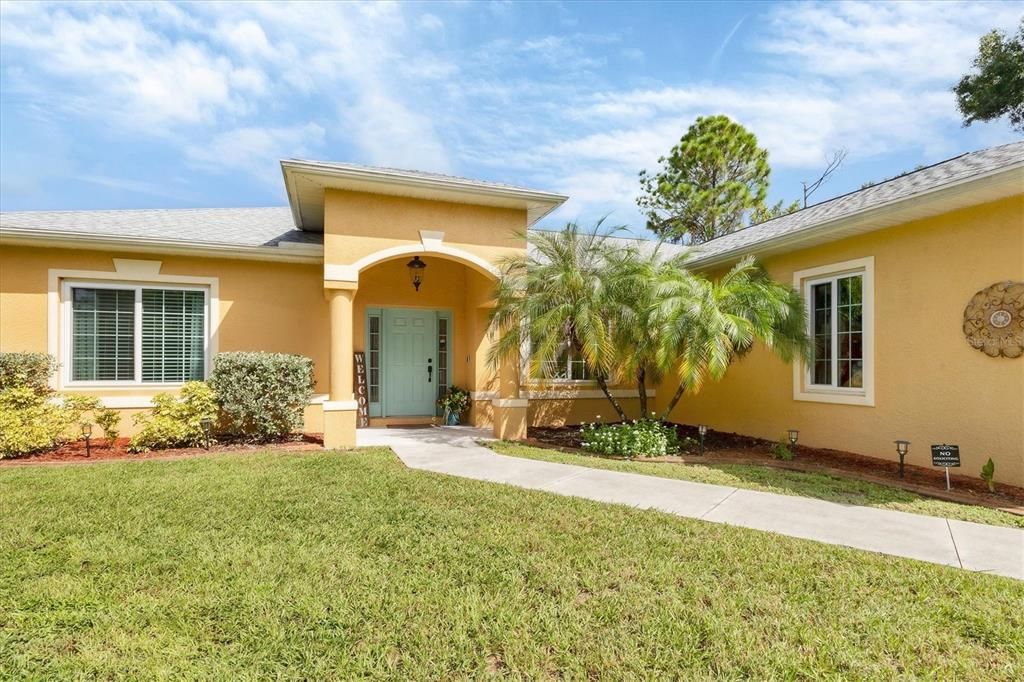 Beautiful front elevation with lush landscaping