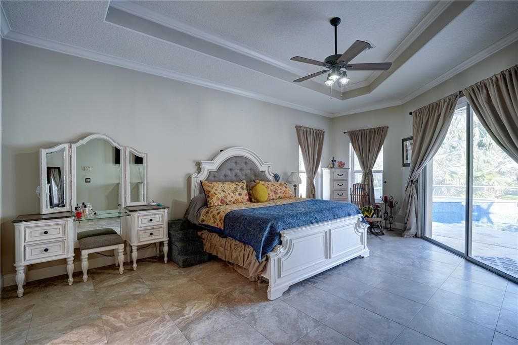 Primary bedroom overlooking the pool & hot tub