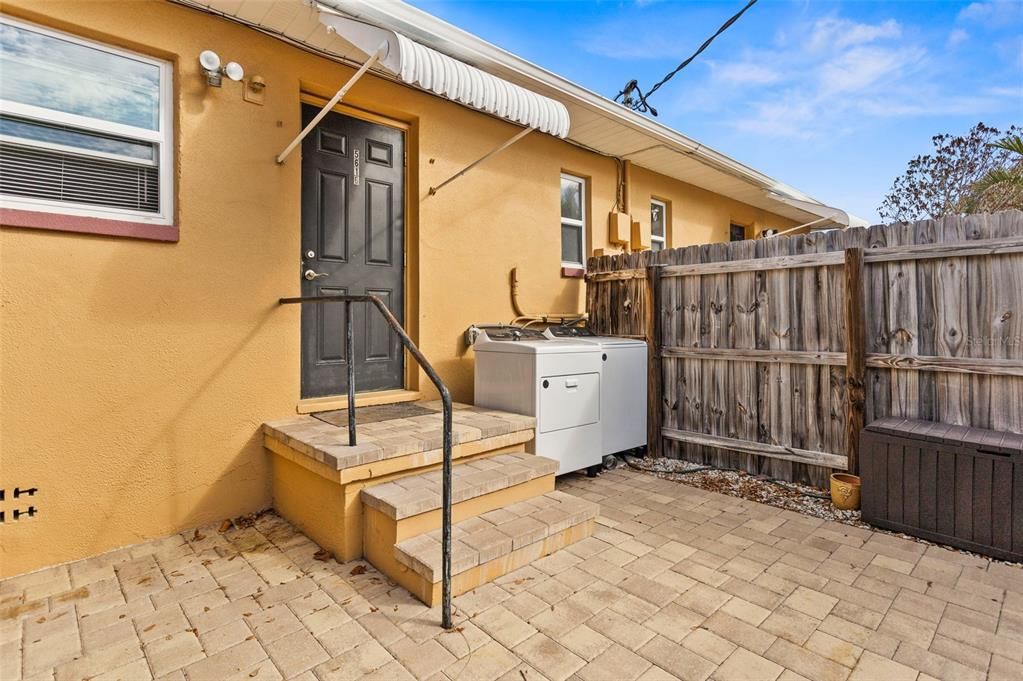 WASHER/DRYER ON PATIO OF 1 BEDROOM UNIT (RAISED AND APPLIANCES ARE NORMALLY COVERED