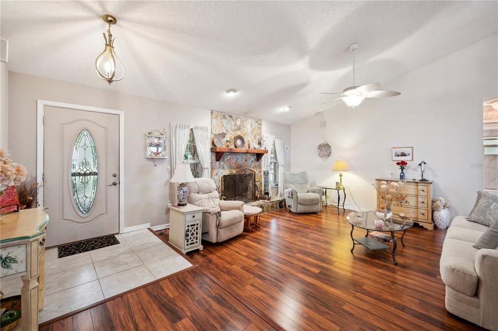 Front entry area and Living Room with fireplace, lending a lovely ambiance to the room