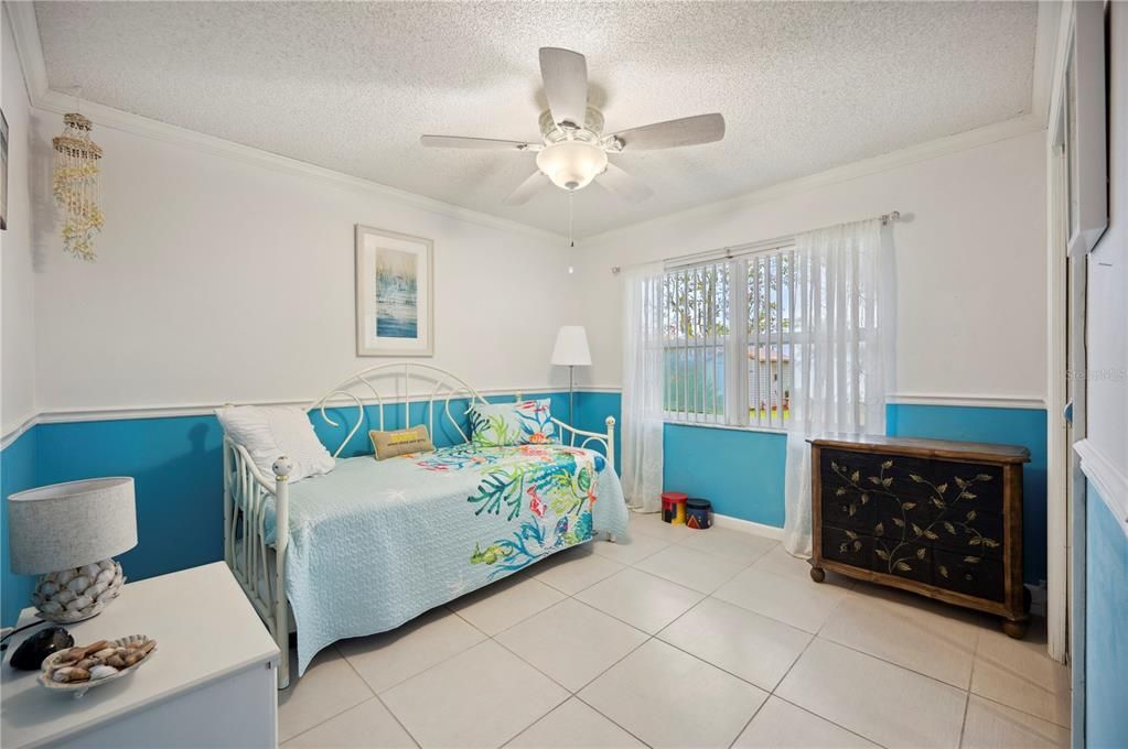 Bedroom 3 with window with view to backyard and lake