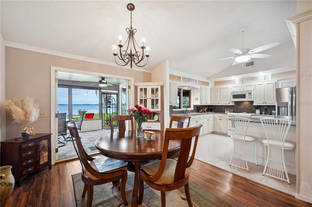 Dining Room with French Doors leading out to screened in back porch and lake beyond