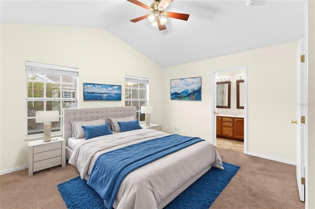 Large master bedroom with walk in closet and en-suite master bathroom virtual staged