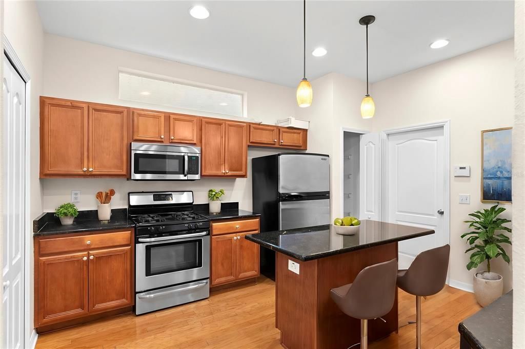 Nice size kitchen with island and stainless appliances virtual staged