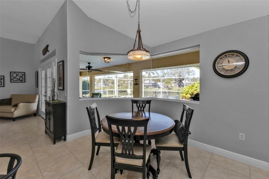 Dinette with aquarium window looking out to the lanai, pool/spa area, and wide basin view of intersecting canals!