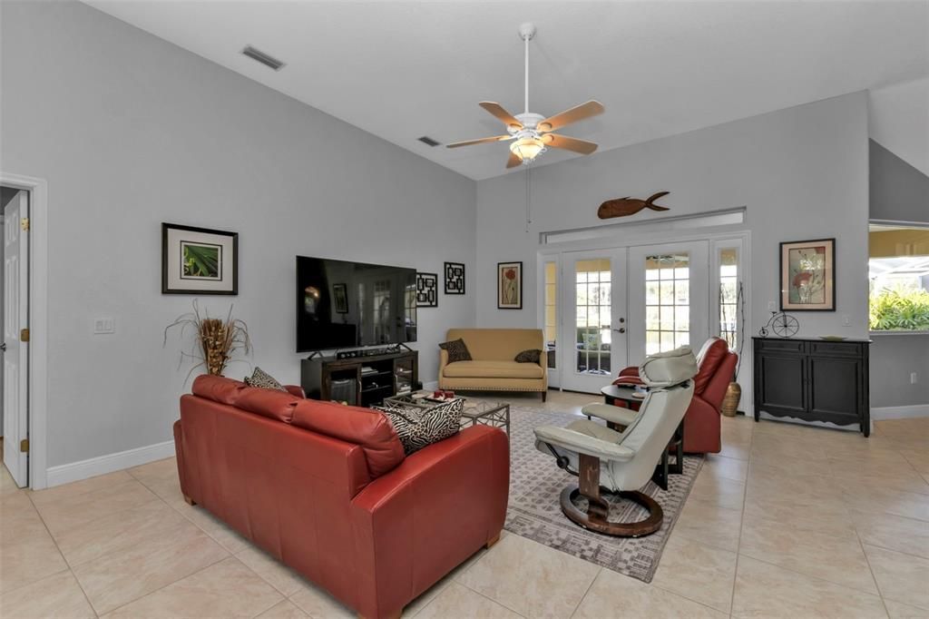 Large great room with  French doors to the lanai and pool area.