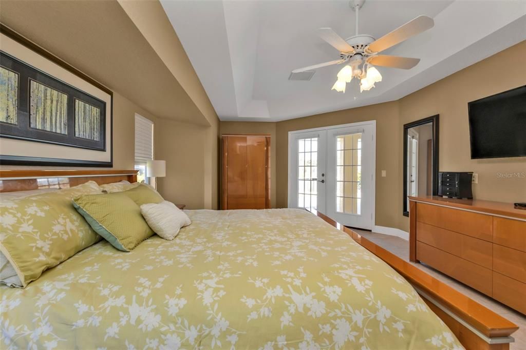 Master bedroom with en suite bath and French doors out to lanai and pool area!