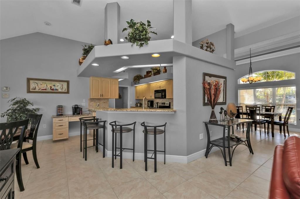 Kitchen with plenty of cabinets, granite countertops, a breakfast bar and built in desk/coffee bar.